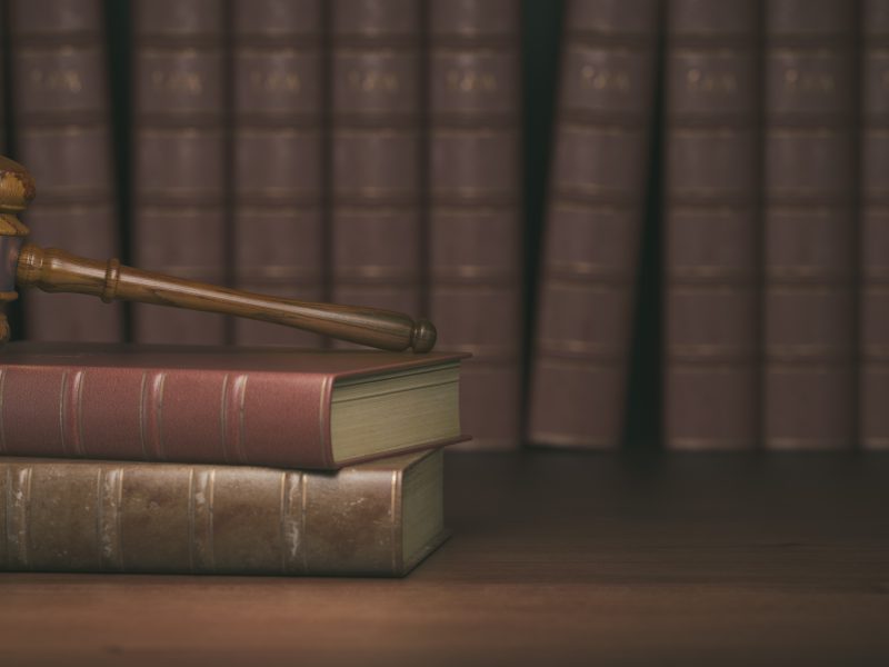 Gavel on the background of vintage lawyer books. Concept of law and justice. 3d illustration